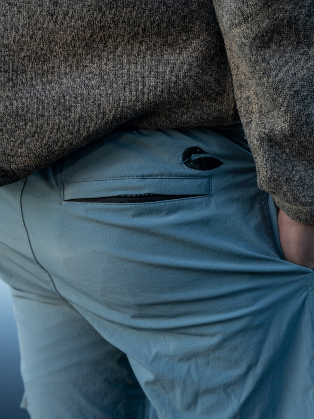 Person wearing blue shorts facing the other direction showing a small loon detail on the back of the shorts.