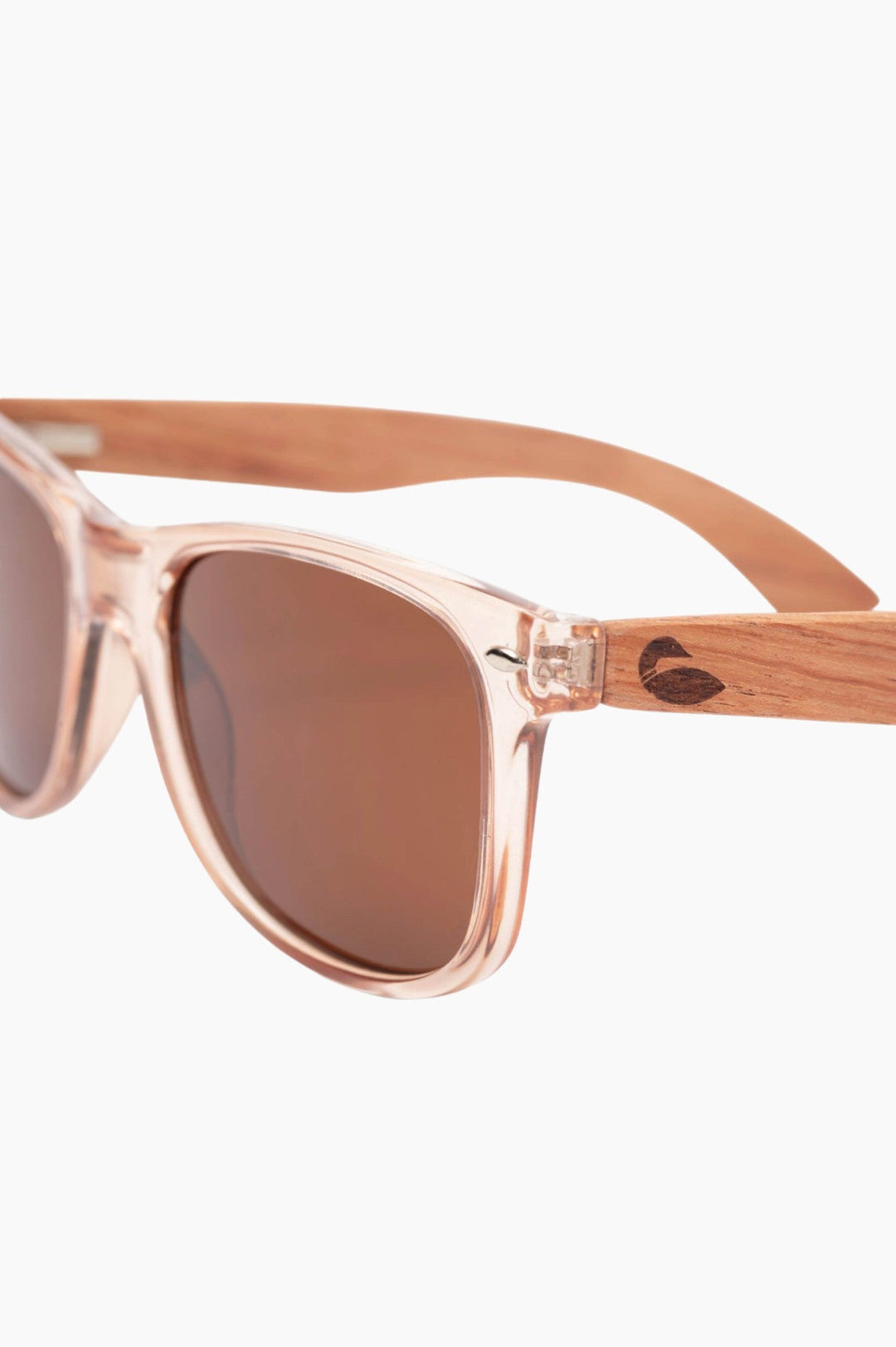 Clear, salmon-tinged framed sunglasses with wood temple pieces and loon logo.