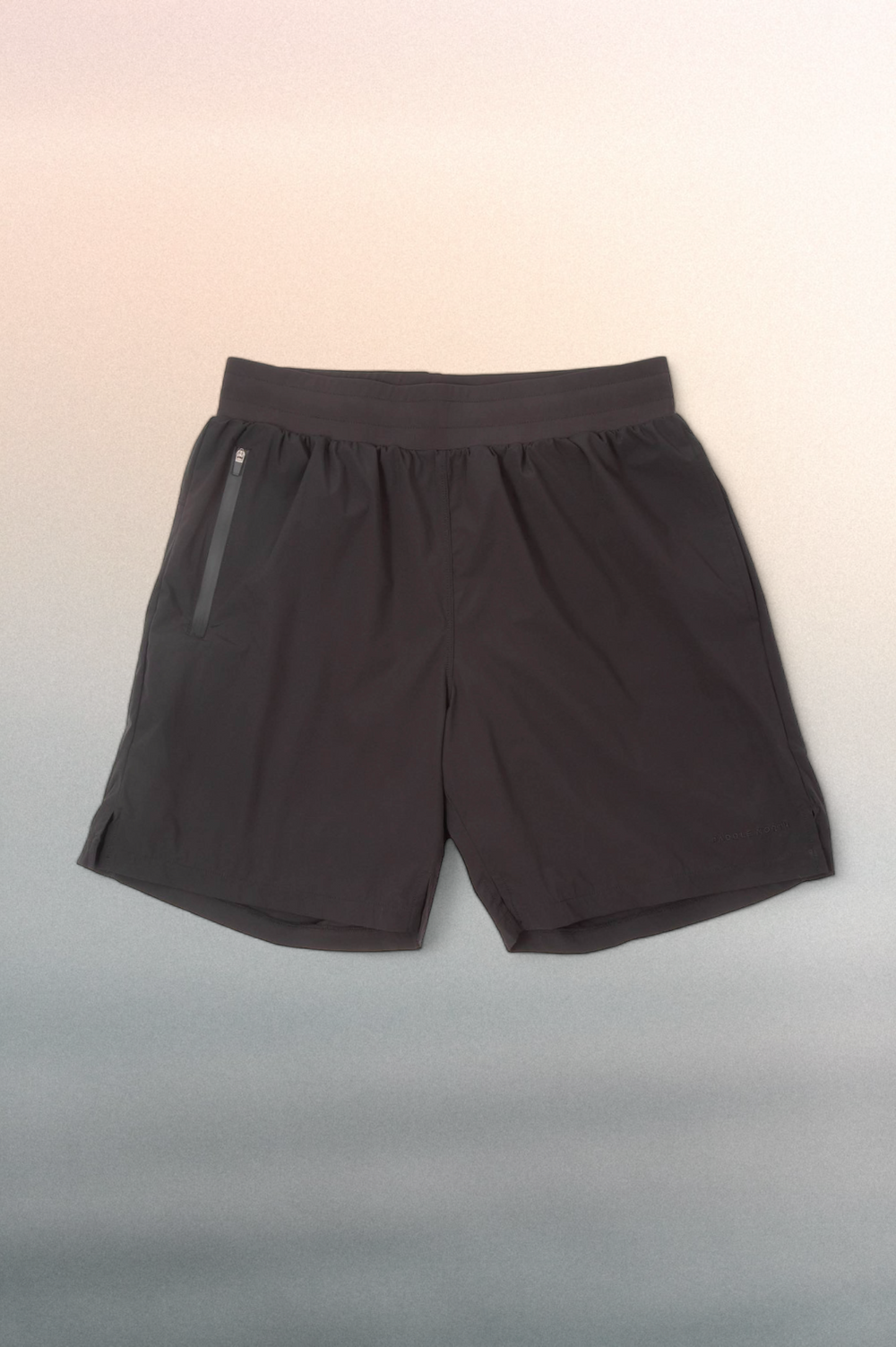 Black short with a black elastic waistband against a blue/pink gradient background.