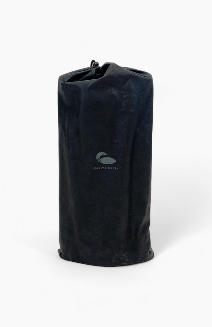 Paddle board accessories: Black manual air pump inside a drawstring bag.