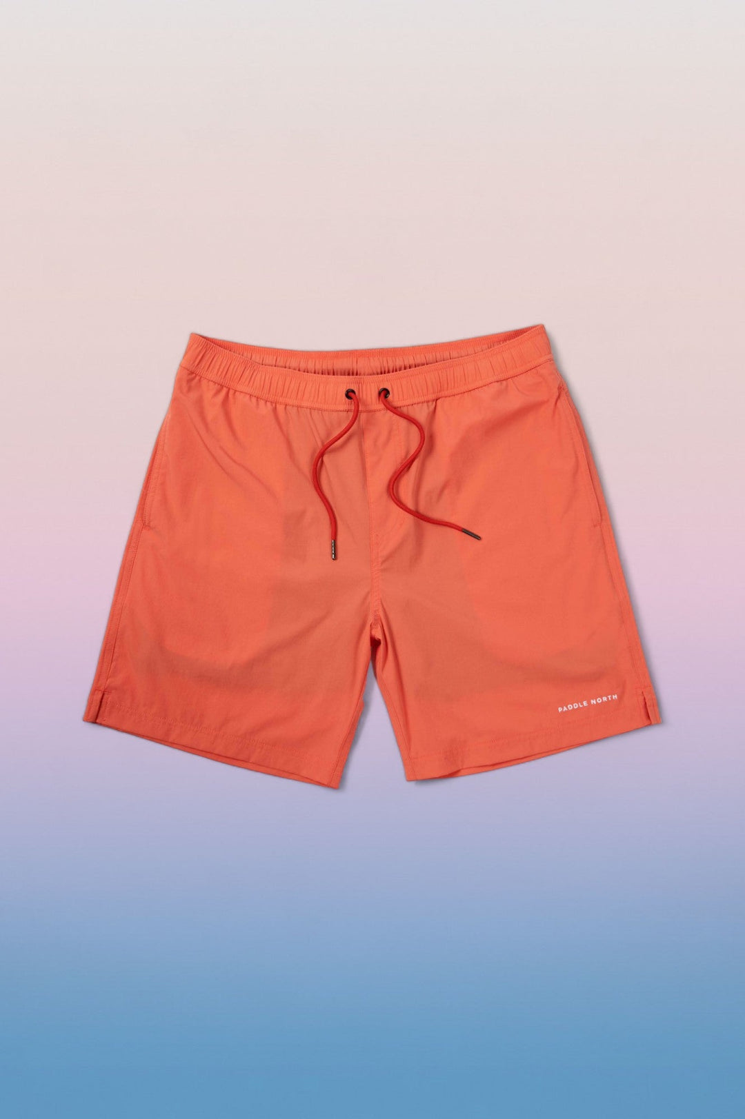 Pair of orange shorts against a blue/purple gradient background.