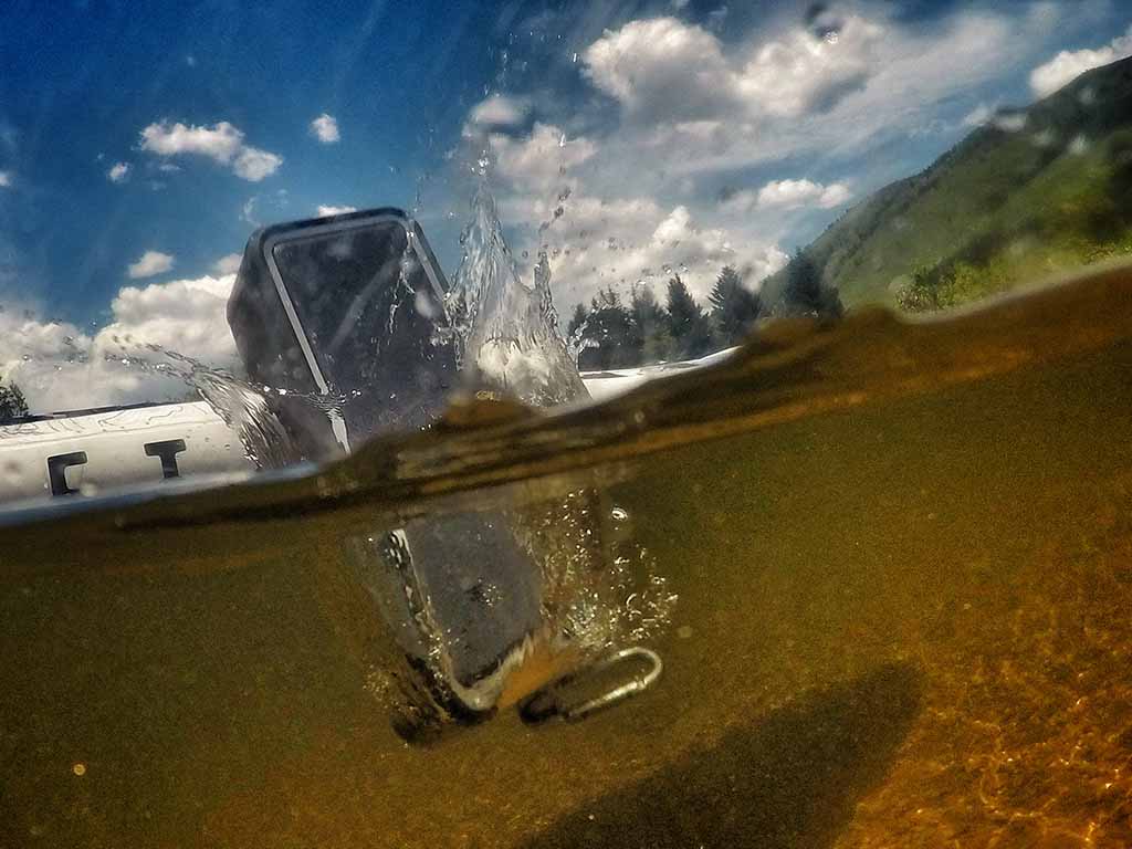 Bluetooth speaker submerged halfway underwater after falling off a SUP